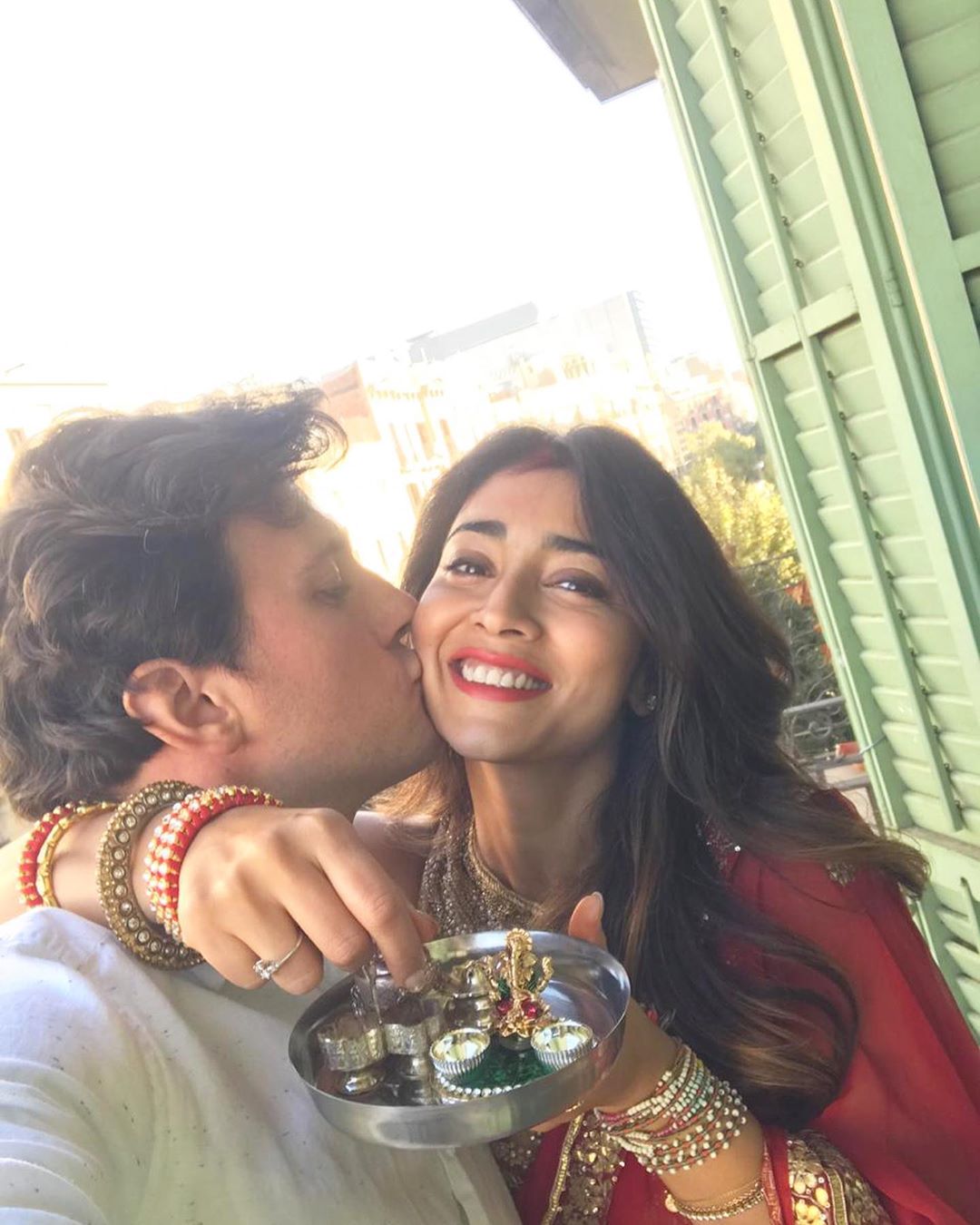  Husband kisses on the cheek of Shriya Saran